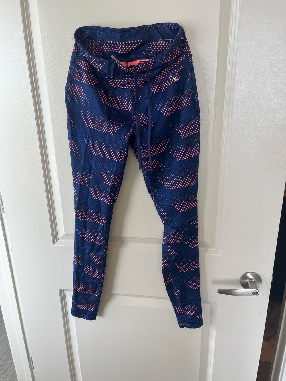 Stretchy fitted Danskin navy leggings with coral polka dots